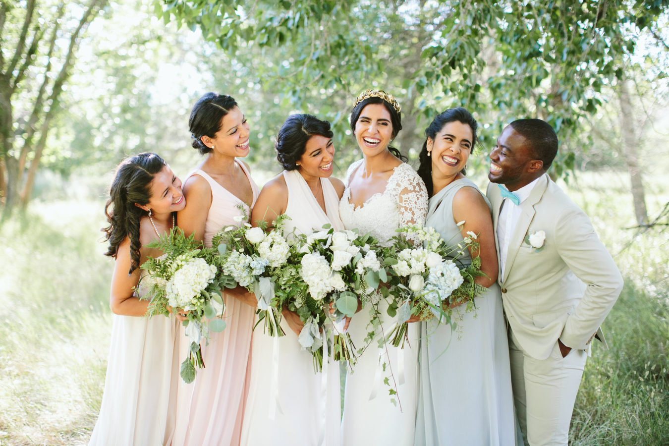 bride laughs with her bridesmaids