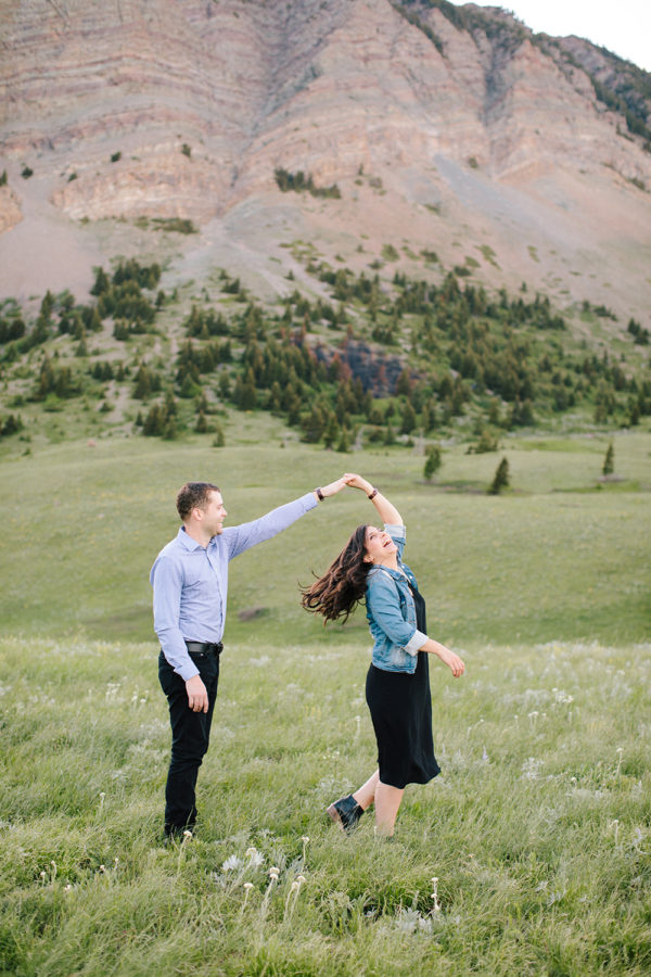 couple playfully dancing during their engagement session in waterton