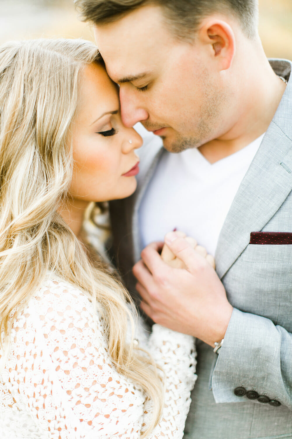 sweet couple embracing for their calgary engagement session