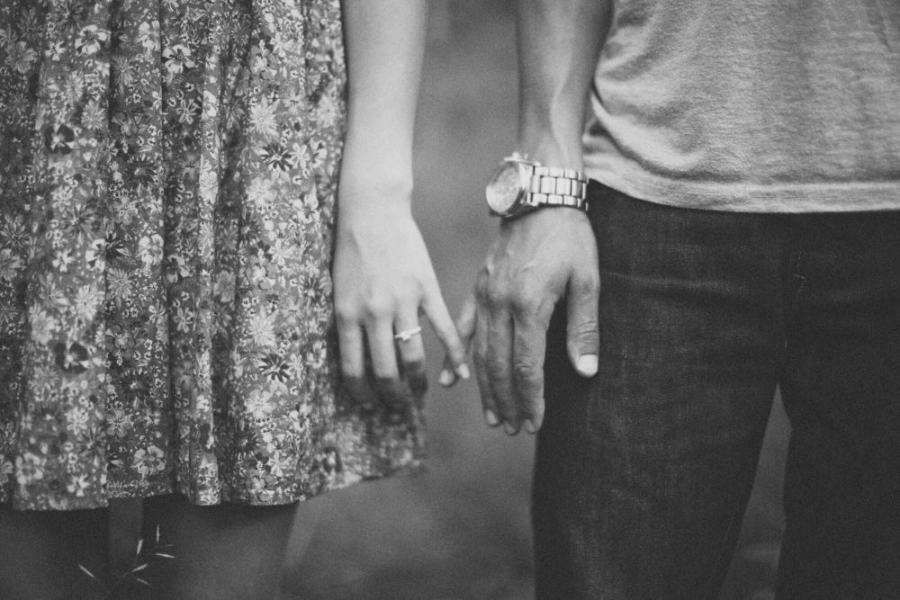 almost holding hands at a park engagement session in calgary